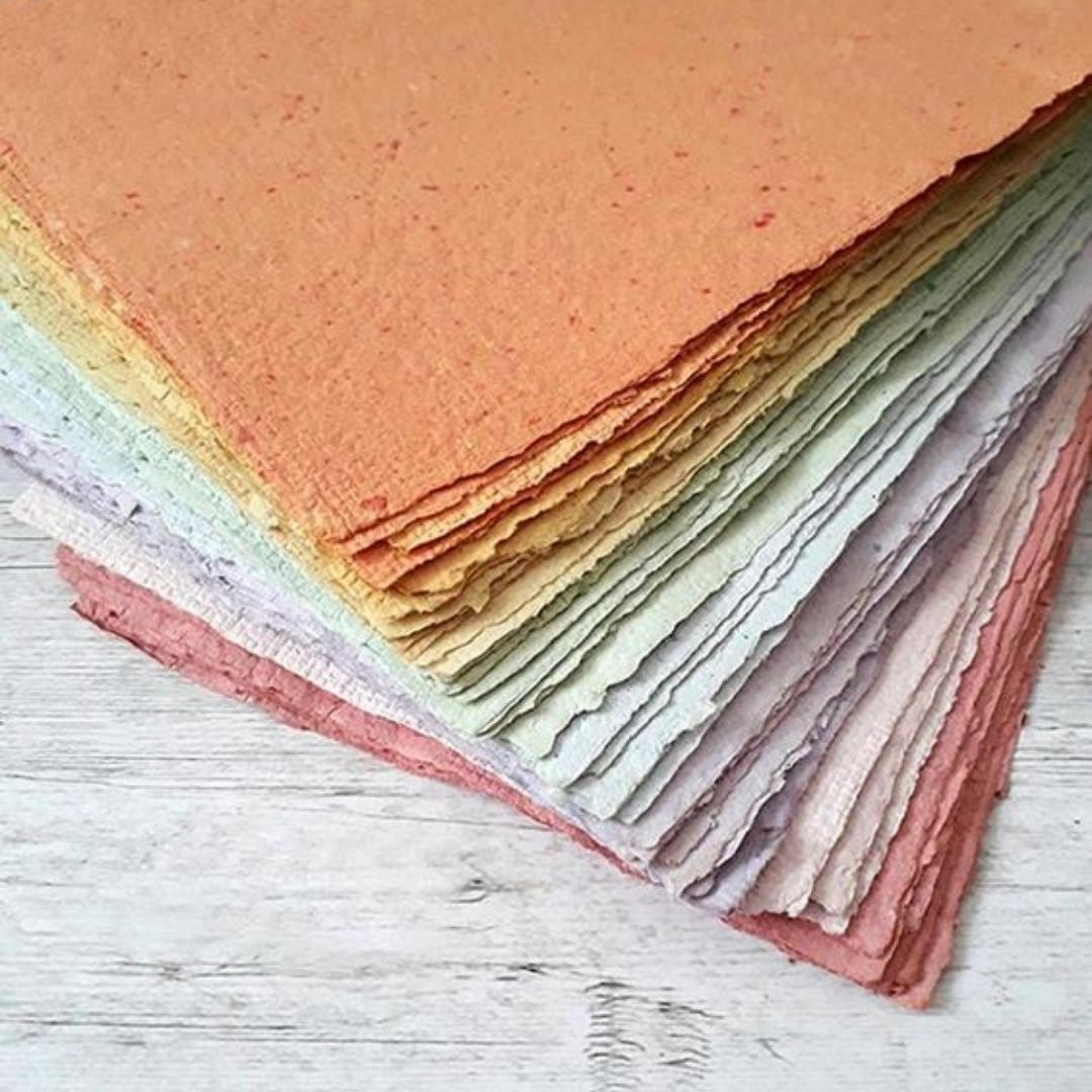 en masse farvet papir der er lavet på en kreativ workshop hvor man lærer og lavet håndlavet papir ud af genbrugsmaterialer