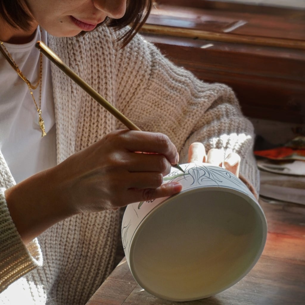 Kursist maler en kop på en kreativ keramik workshop